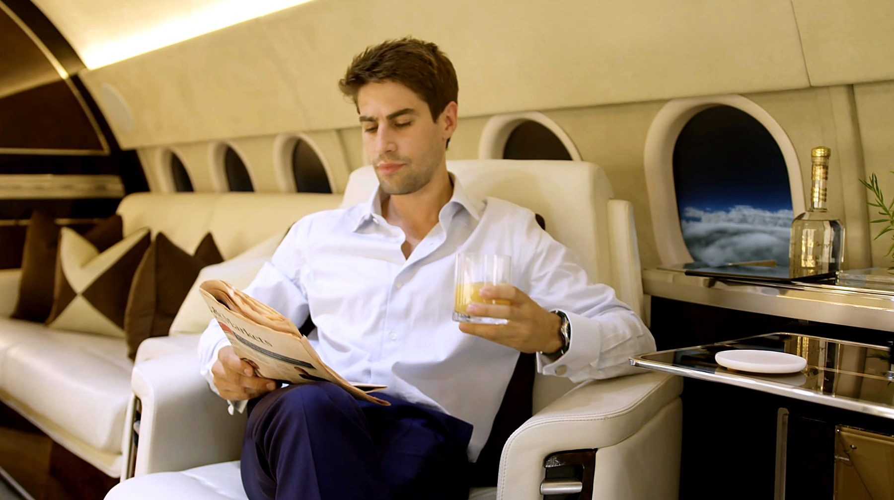 An executive reading on a private jet